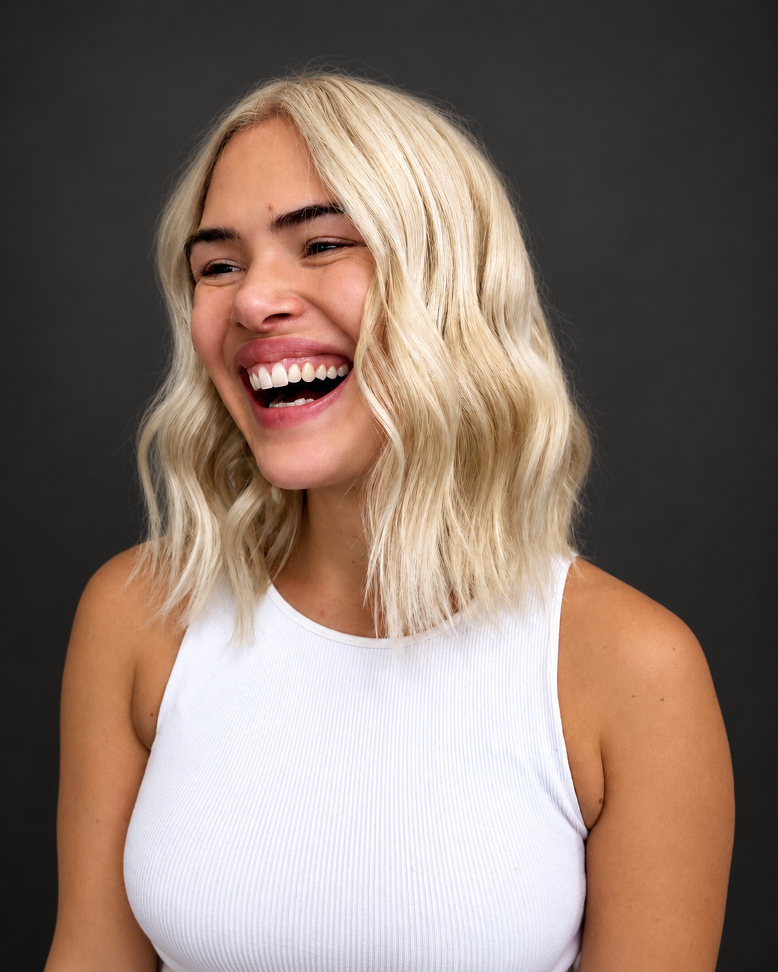 Textured blonde bob with bright smile by Bradley Sanders
